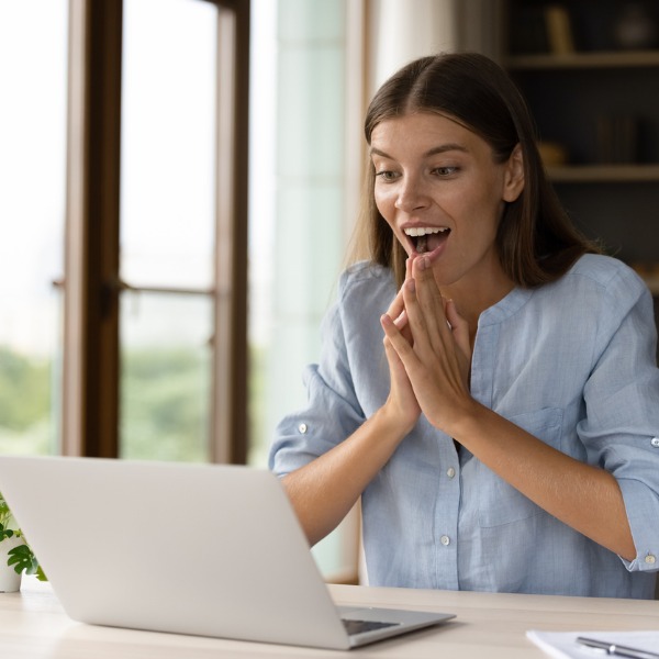 NBG_happy_surprised_young_businesswoman. NBG Young woman surprised by offer